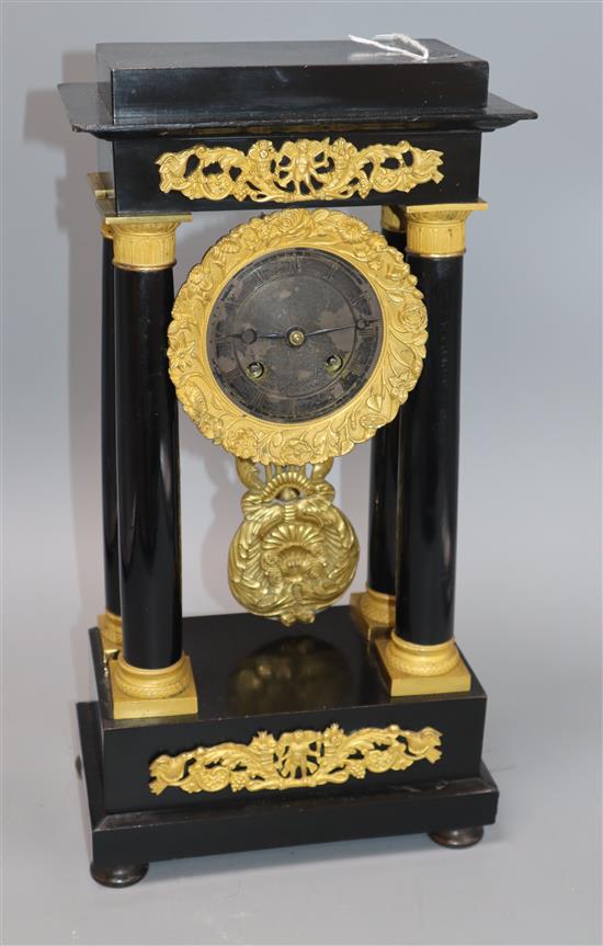 An ebony and gilt portico clock H.40cm